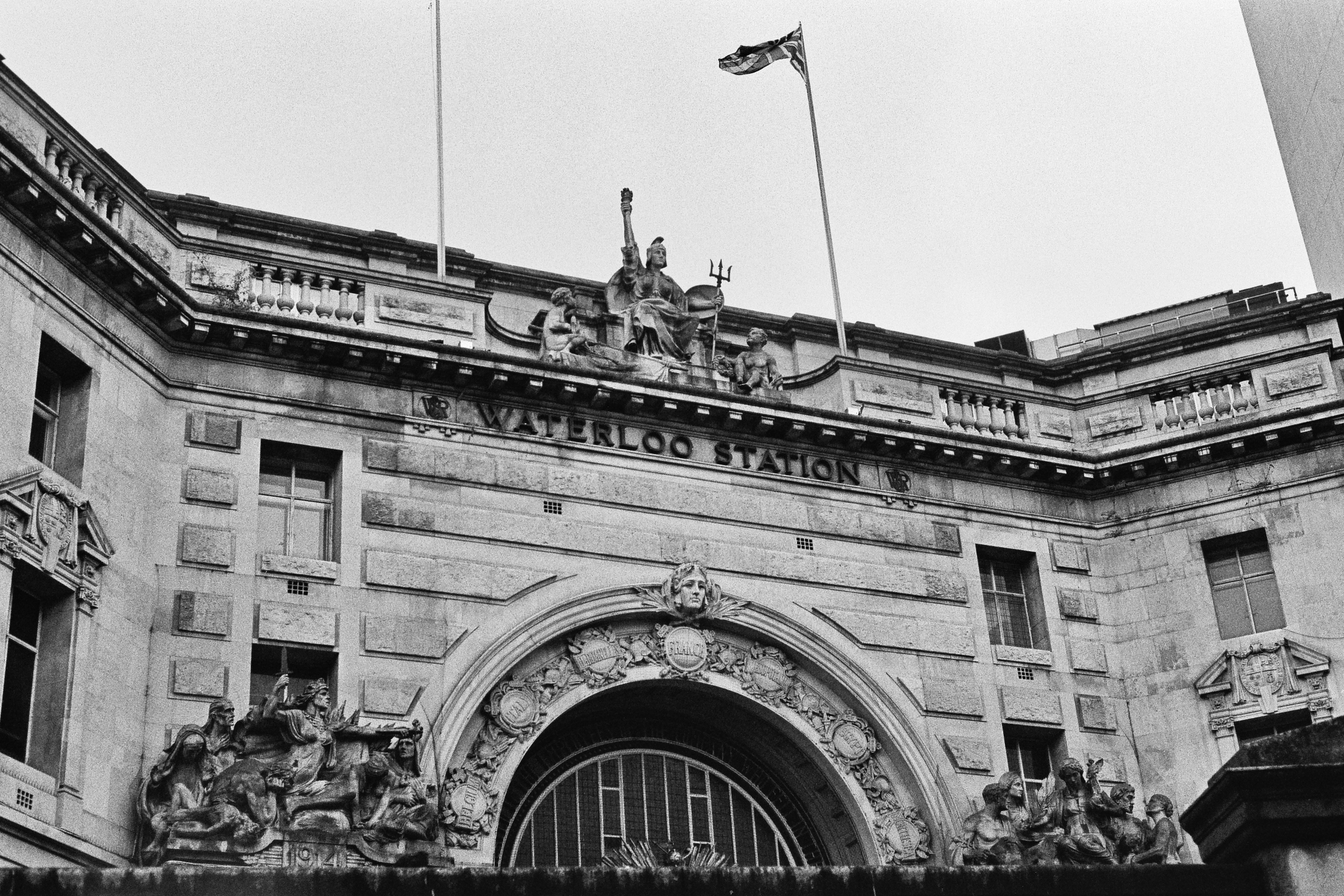 A black and white photograph of Waterloo train station