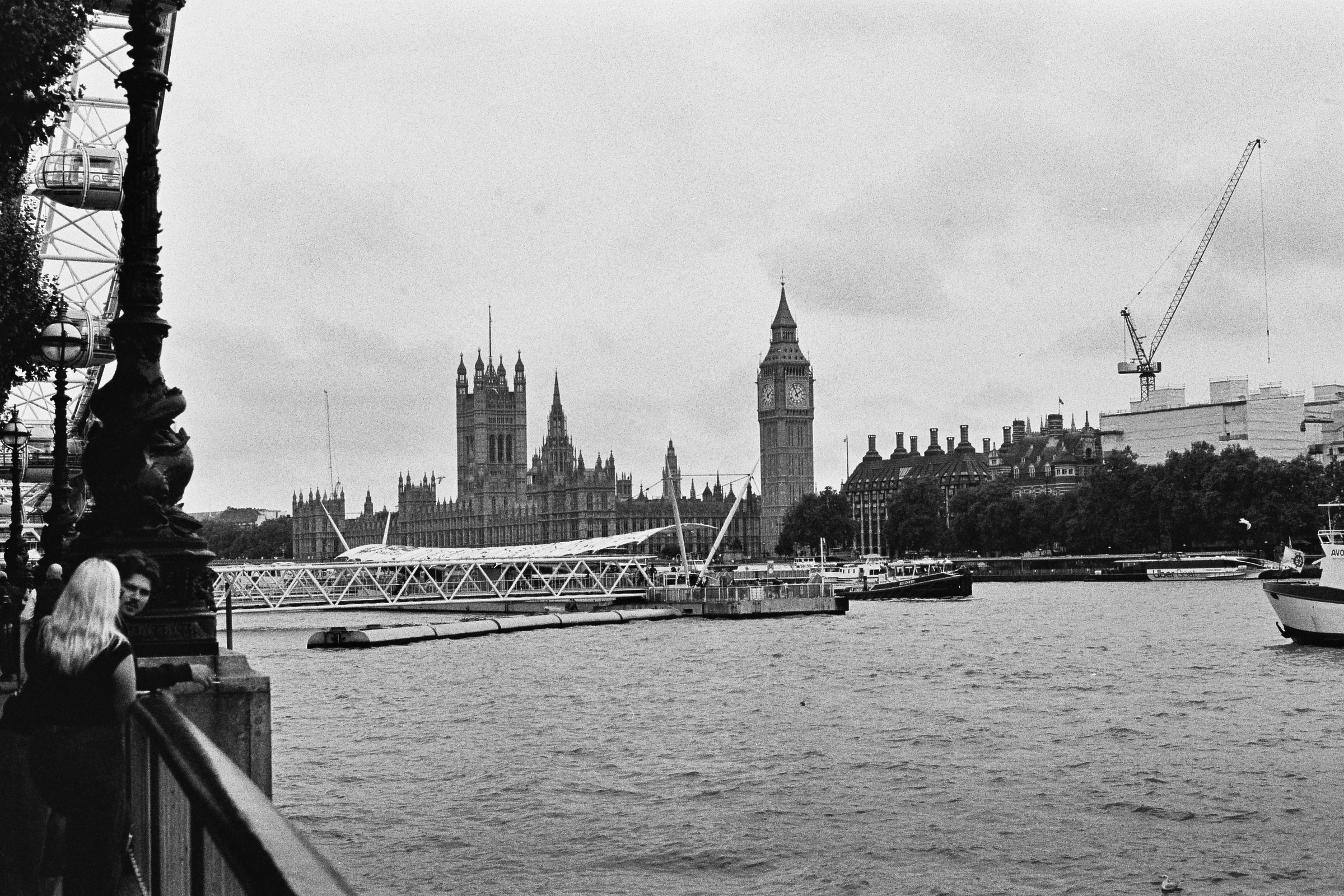 A black and white photograph of Big ben and The houses of parliament across the river